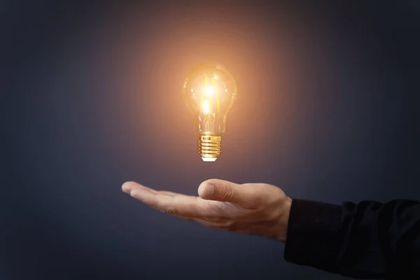 stock image Knowledge idea bulb concept. Electric light bulb in hand business manager. Innovation, brain, creative concept. High quality photo