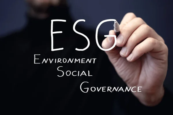 ESG strategy concept. Environmental, sustainable, governance. Businessman writes ESG. High quality photo