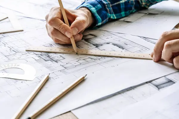Architectural engineering design plan drawing on the table. Architects work on table in studio. Construction design and plan. High quality photo