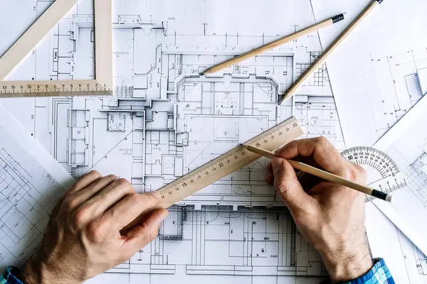 Architectural engineering design plan drawing on the table. Architects work on table in studio. Construction design and plan. High quality photo