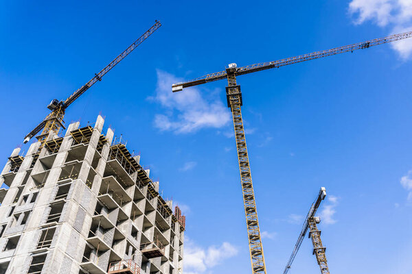Construction industry building. Construction industry site with cranes, fittings and concrete. High quality photo