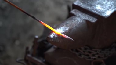 Demirci bir demircide örsün üzerinde çalışıyor. Sıcak metal dövmesi. Yüksek kaliteli FullHD görüntüler