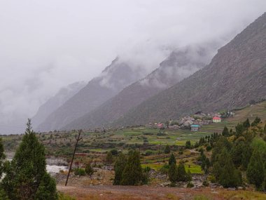 Lahaul and Spiti, Himachal Pradesh, India - 12 September 2021 : Village in Mountains covered by clouds.