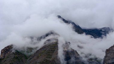 Lahaul and Spiti, Himachal Pradesh, India - 07 September 2021 : Himalayan landscape with peaks covered by clouds in mountains