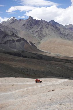 Ladakh, India - August 24th, 2022: Offroad vehicle goes on the mountain on empty road of ladakh in india