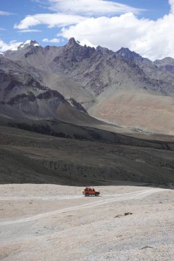 Ladakh, India - August 24th, 2022: Offroad vehicle goes on the mountain on empty road of ladakh in india