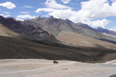 Ladakh, India - August 24th, 2022: Offroad vehicle goes on the mountain on empty road of ladakh in india