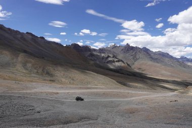 Ladakh, India - August 24th, 2022: Offroad vehicle goes on the mountain on empty road of ladakh in india