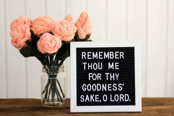 a bible verse on a sign board with three jars of purple flowers