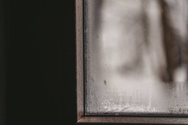 Water drops and condensation on the window glass in winter weather