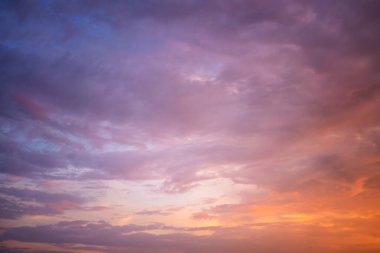Beautiful bright multicolored sunset sky with yellow and pink hues, natural abstract background texture