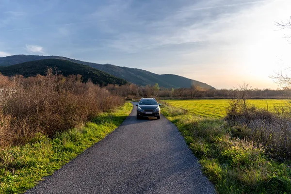 Gray Car Drives Road Green Field Spring Mountains — Stock Photo, Image