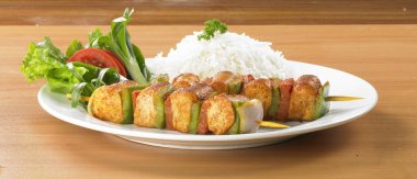 Pilau pilavıyla servis edilen tavuk tikka kebabı.