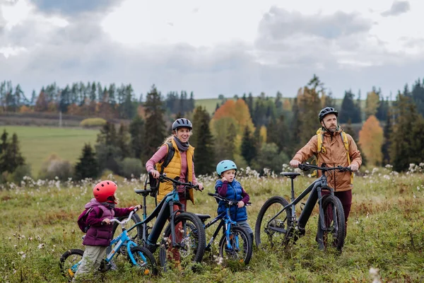 在秋天里 有小孩骑自行车的年轻家庭 健康生活方式的概念 — 图库照片