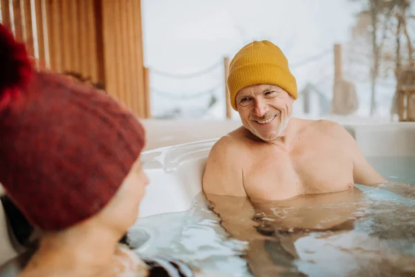 Senior Couple Knitted Cap Enjoying Together Outdoor Bathtub Terrace Cold — Stock Photo, Image