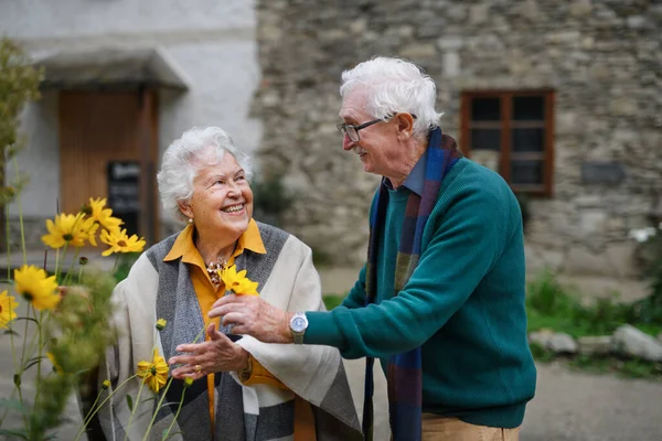 Sonbahar Şehir Yürüyüşünde Çiçeklerle Poz Veren Mutlu Yaşlı Çift — Stok fotoğraf