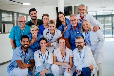 Portrait of happy doctors, nurses and other medical staff in a hospital. clipart
