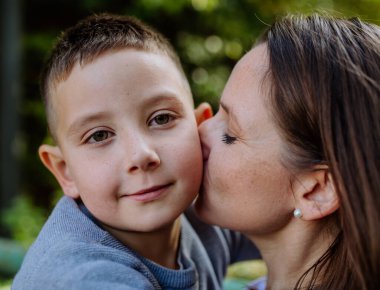 Portrait of mother with her son in a forest.