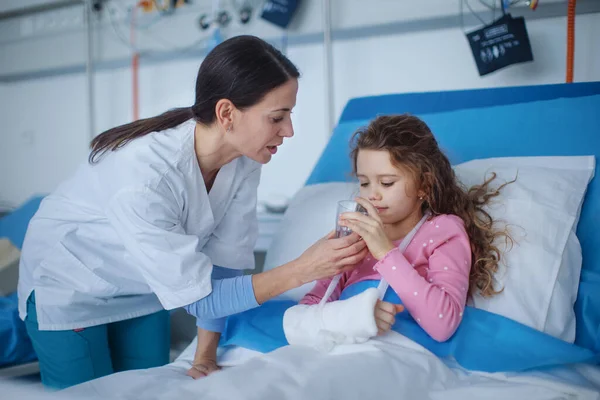 Young Nurse Giving Glass Water Little Girl — Photo