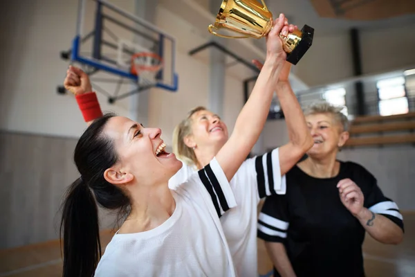 Группа Молодых Пожилых Женщин Баскетболистки Тренажерном Зале Трофеем Празднования Победы — стоковое фото
