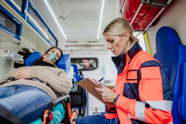 Rescuer Taking Care Patient Writing Medical Record — Stock Photo, Image
