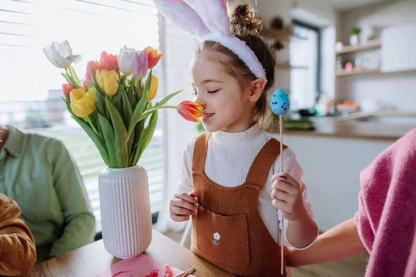 Little Girl Smelling Bouquet Tulip Flowers Decorating Easter Eggs Her — Stockfoto