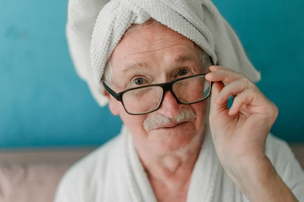 Happy Senior Man Glasses Sitting Sofa Bathrobes Looking Camera — Fotografia de Stock