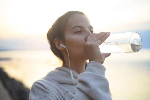 Young Beautiful Sportive Girl Listening Music Drinking Water Sunrise Lake — Foto Stock