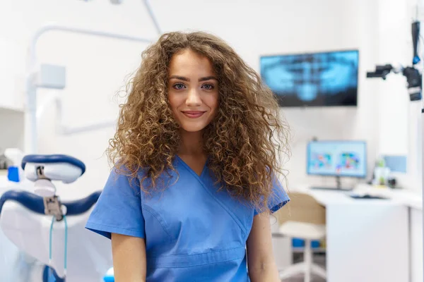 Portrait of young woman dentist at a private dental clinic.