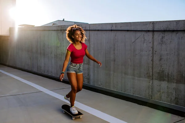 Multiracial Teenage Girl Riding Skateboard Front Concrete Wall Balancing Side — Stok Foto