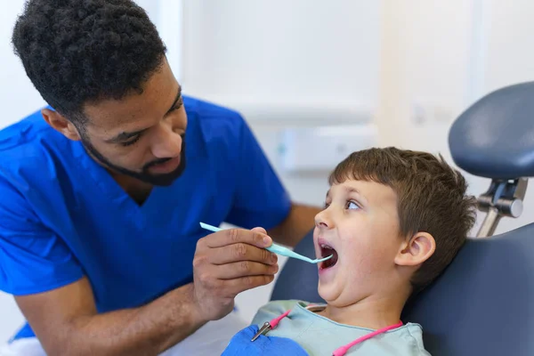 歯医者の診察中に歯医者の椅子に座っている小さな男の子 — ストック写真