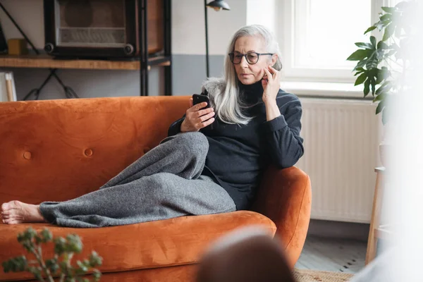 Старша Жінка Відпочиває Дивані Смартфоном — стокове фото