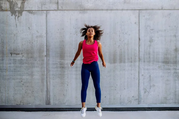 Young Multiracial Girl Jogging Jumping City Front Concrete Wall Side — Foto Stock