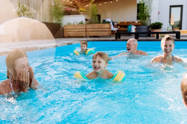Multi Generation Family Having Fun Enjoying Swimming Backyard Pool — Foto de Stock