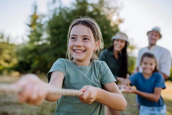 Young Family Happy Kids Having Fun Together Outdoors Pulling Rope — Stockfoto
