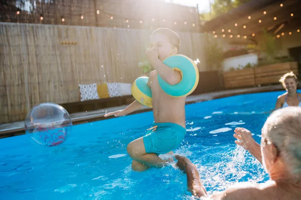 Grandfather His Granson Having Fun Together Jumping Swimming Pool Backyard — Foto de Stock