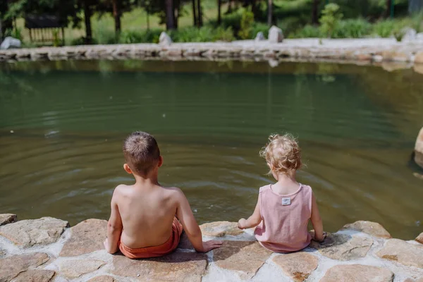 Cute Girl Boy Sitting Together Footpath Lake Dangle Feet Water — Stockfoto