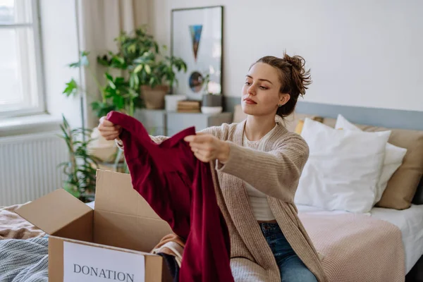 Young Woman Giving Her Clothes Packed Box Charity — Stock Photo, Image