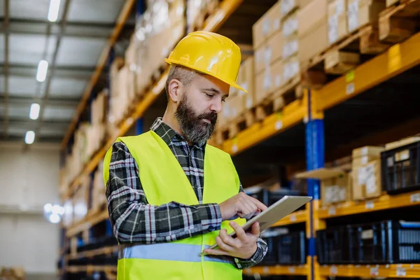 stock image Portrait of a warehouse worker or a supervisor with digital tablet.