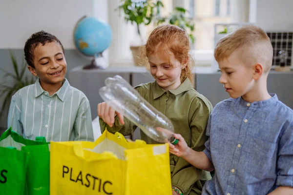 stock image Children separating rubish in to a bins.