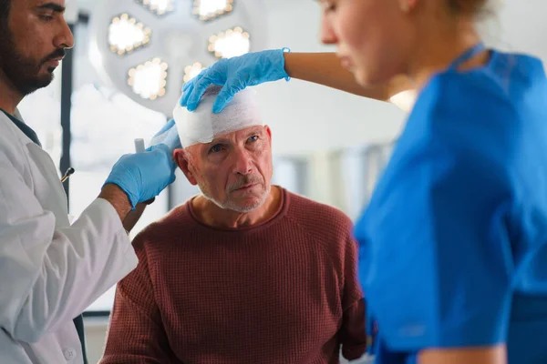 Close Doctor Nurse Treating Injured Head Senior Man — Stock Photo, Image
