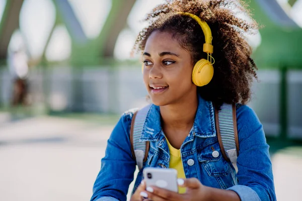 Multiracial Teenage Girl Backpack Headphones Smartphone Resting School City Bridge — Zdjęcie stockowe