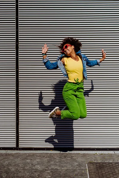 Young Happy Multiracial Teenage Girl Red Sunglasses Afro Hairstyle Jumping —  Fotos de Stock