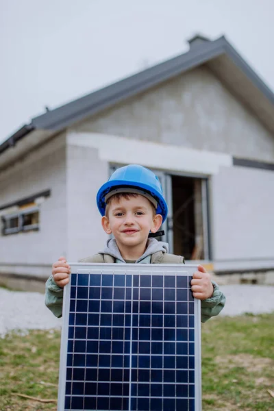 Portrait Little Boy Holding Solar Panel Front New Unfinished House — Stock Photo, Image