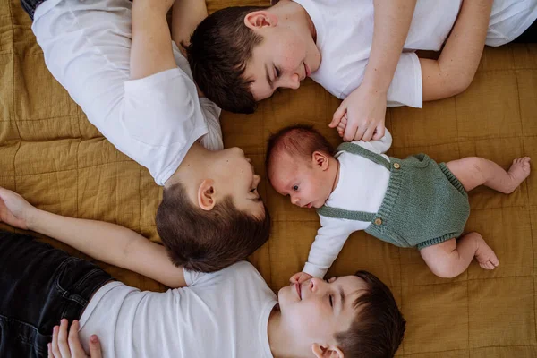 Three Big Brothers Newborn Brother Lying Bed — Stock Photo, Image