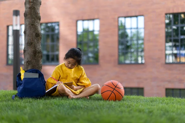 Little Asian Girl Sitting Public Park Writing Some Notes Summer — Foto Stock