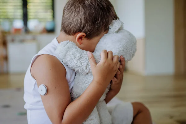 Diabetic Boy Continuous Glucose Monitor Sitting Home Hugging His Stuffed — Stock Photo, Image