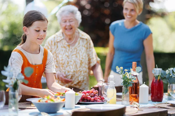 Grandmother Mother Daughter Setting Table Summer Garden Party Bringing Plates — Stock Photo, Image