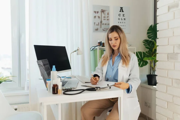 Young Beautiful Female Doctor Working Laptop Doctors Office Physician Doing Royalty Free Stock Photos