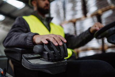 Forklift kullanan çok ırklı depo işçisinin eli kapalı. Depo işçisi nakliye, teslimat ve depodaki stokları kontrol etmek için ürünler hazırlıyor..